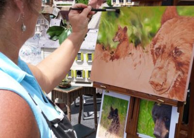 artist painting a painting of bear
